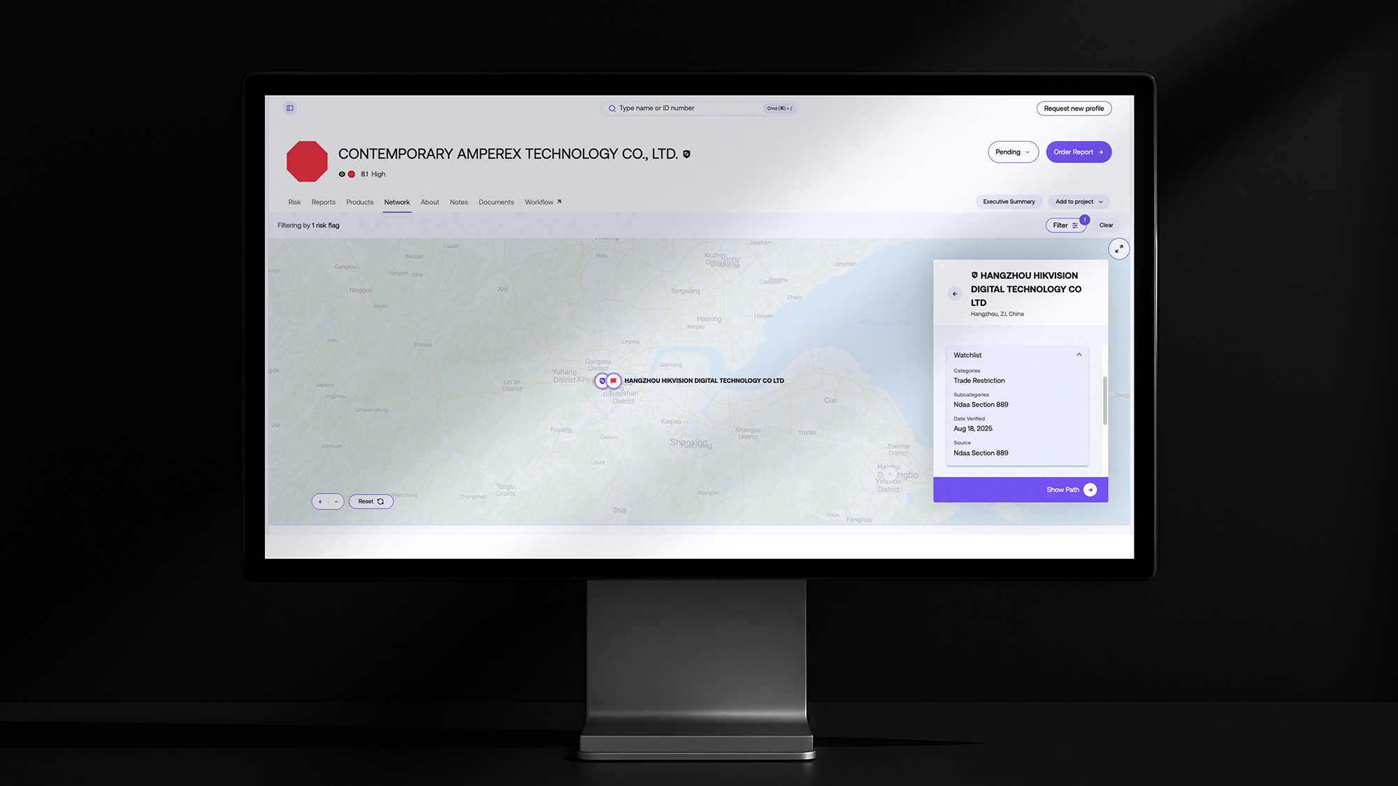 Monitor displaying Exiger’s 1Exiger Risk & Compliance platform with supplier map highlighting Hangzhou Hikvision Digital Technology Co. flagged under trade restriction watchlist, Ndaa Section 889 compliance.