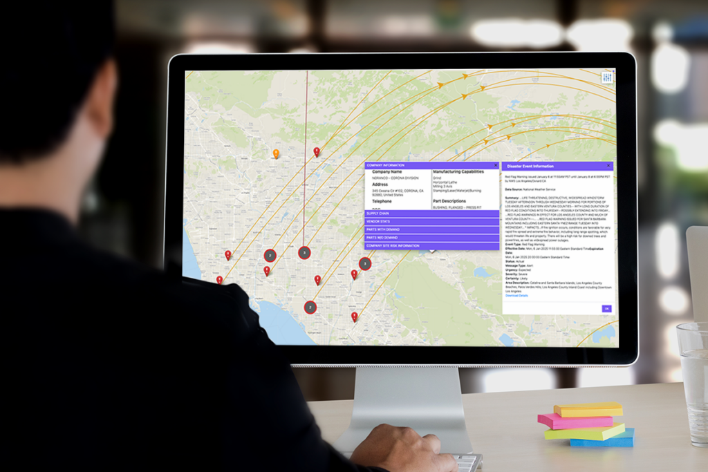 Person using the Exiger Knowledge Graph on a desktop computer to analyze a digital supply chain risk map, showing supplier locations and connections across Southern California with company and disaster event details displayed on-screen.